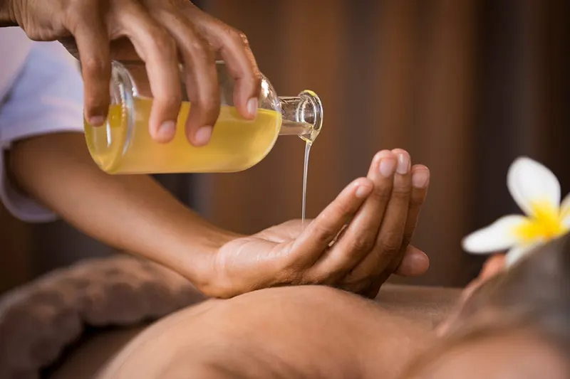 Hot oil massage at home in Dubai — warm aromatic oil therapy for deep relaxation
